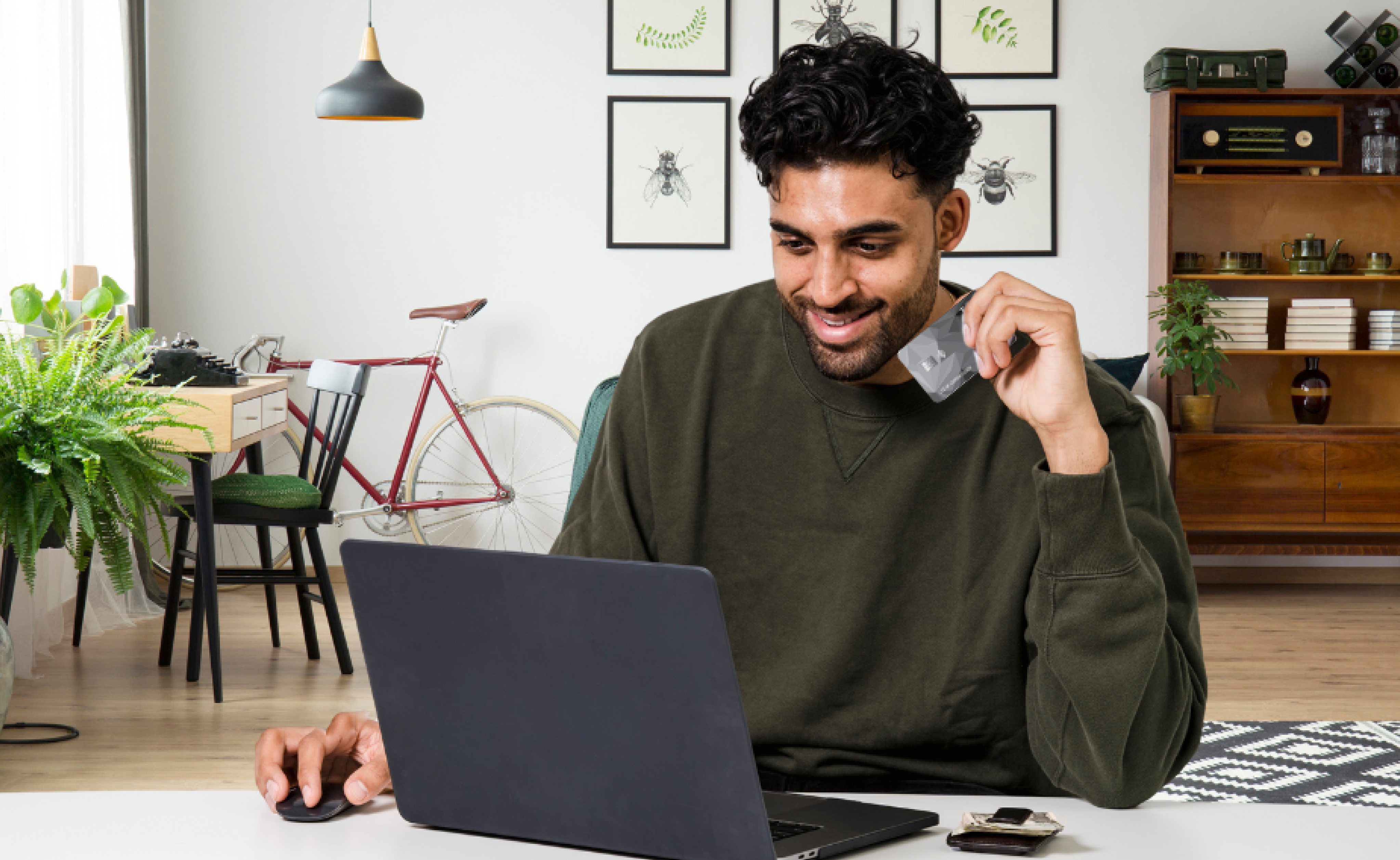Guy holding Taz credit card